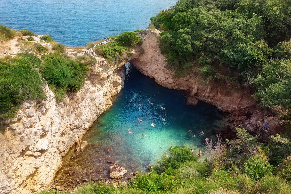 People swimming in Regina Giovanna Queen's bath near Sorrento, Italy