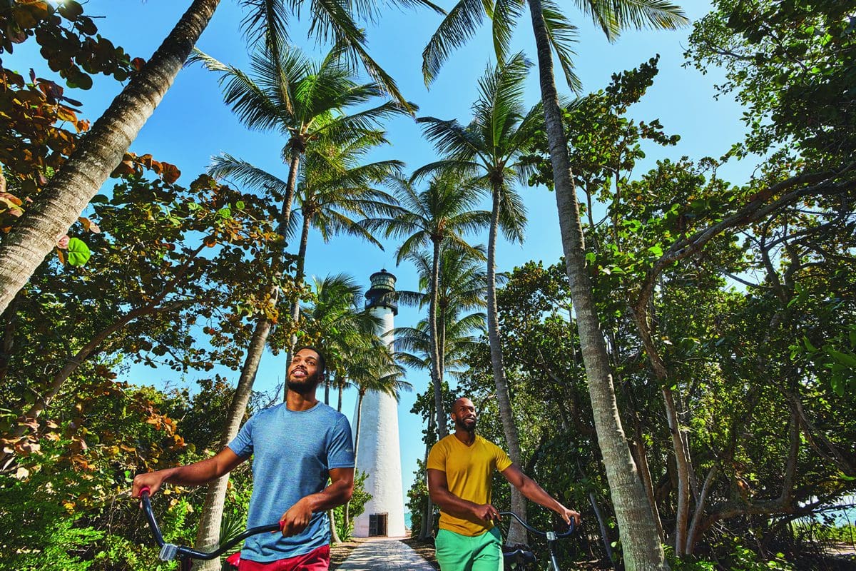 Cycling by the lighthouse at Bill Baggs Cape Florida State Park - GMCVB