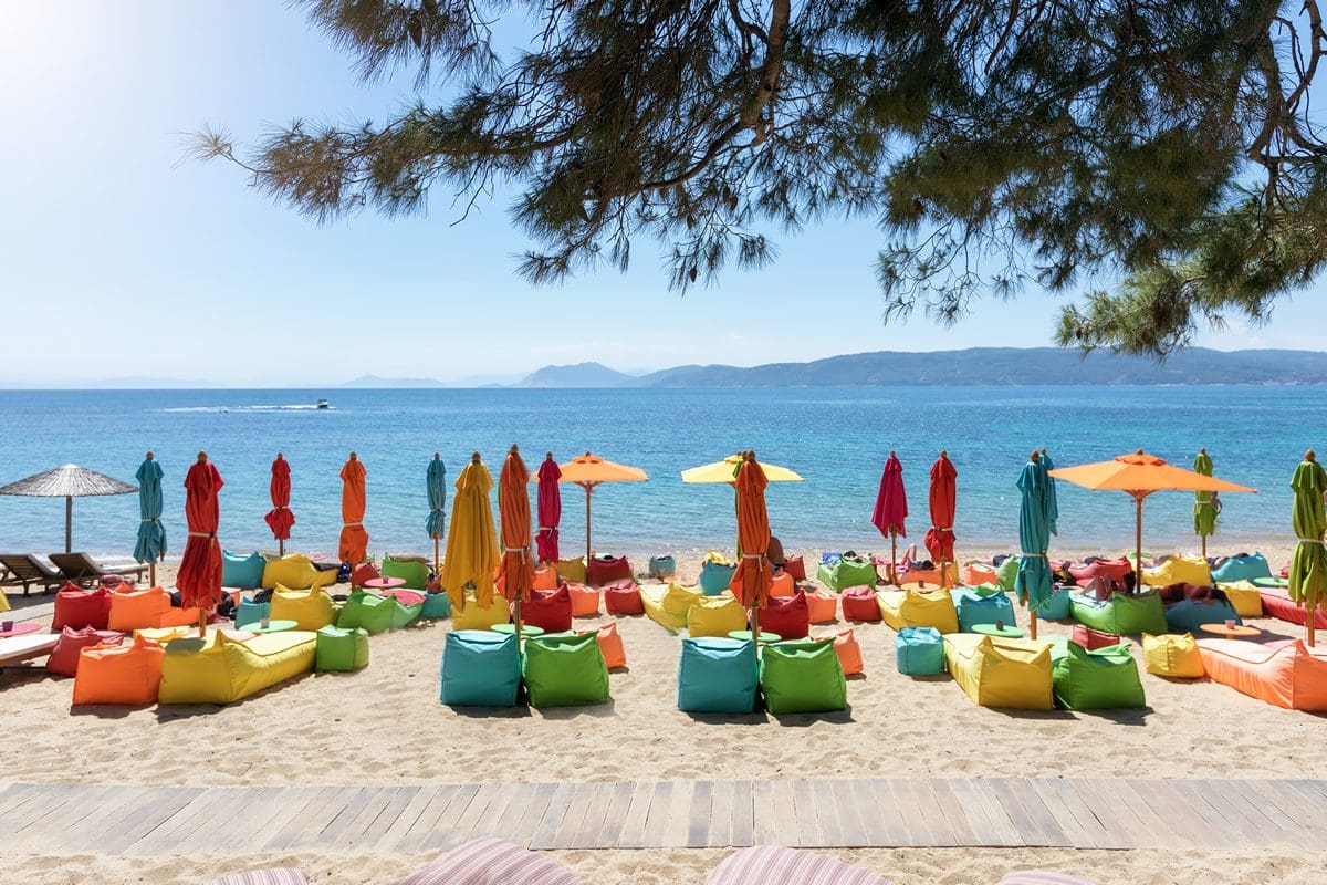 Colourful umbrellas and sun loungers on Agia Eleni Beach in Skiathos