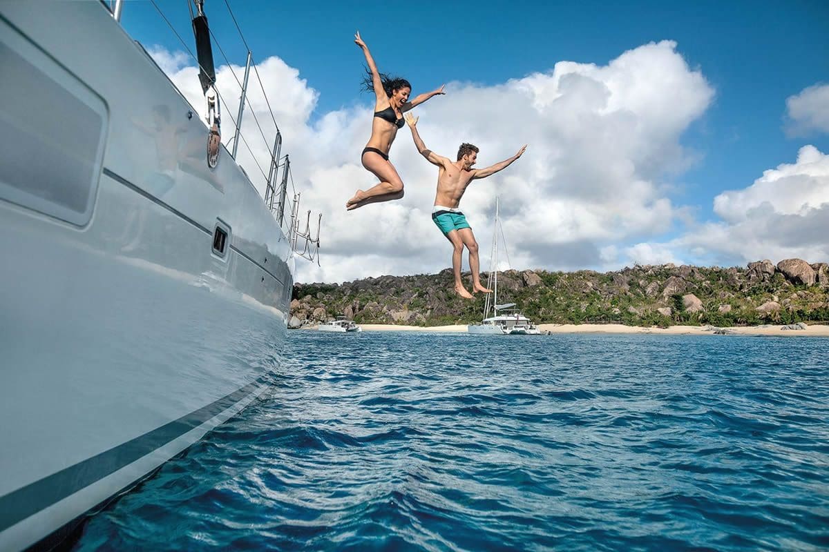 Couple diving from a boat - BVI Tourism