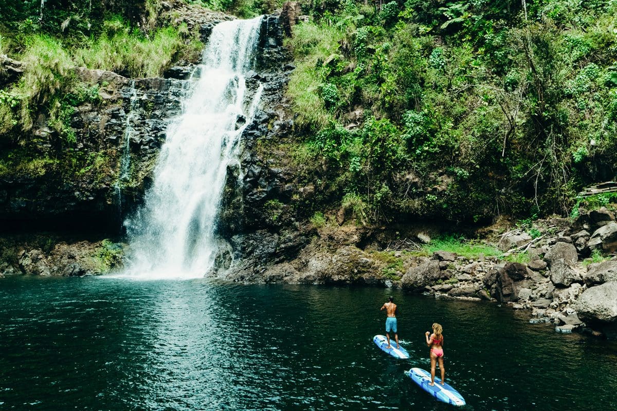 Couple paddleboarding at Kulaniapia Falls on the island of Hawaii - Hawaii Tourism Authority