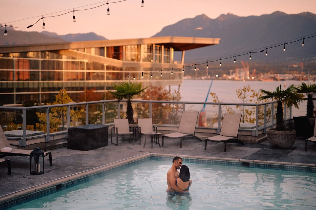 Couple in the rooftop pool at Fairmont Waterfront, Vancouver - Destination BC