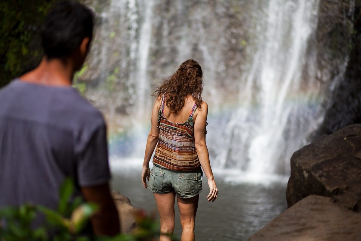 Couple exploring a waterfall - Hawaii Tourism Authority