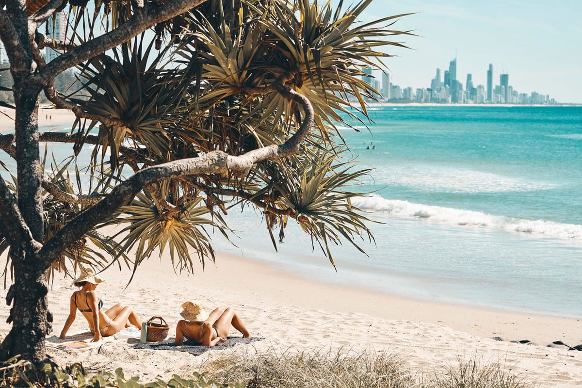 Enjoying the sun on the beach at Burleigh Heads on Queensland's Gold Coast - Tourism Australia