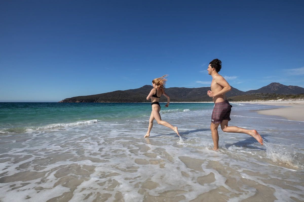 Enjoying the waters of Wineglass Bay in Freycinet, Tasmania - Tourism Australia
