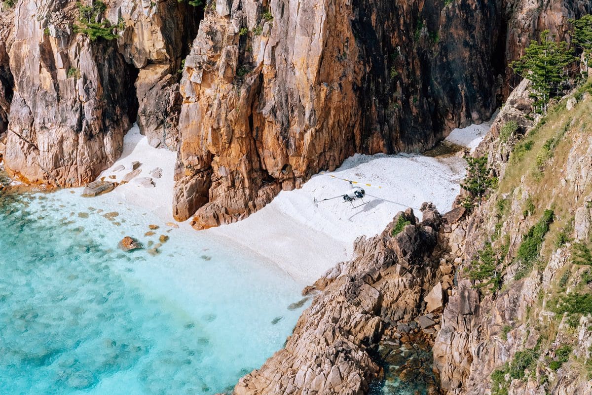 Helibiz helicopter on the remote Hayman Island Beach in the Whitsundays - Tourism Australia