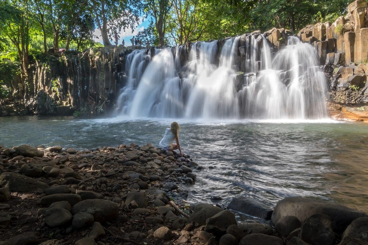 Lady experiencing the cool waterfalls - Mauritius Tourism