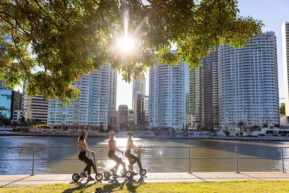 Riding e-bikes along Brisbane River - Tourism Australia