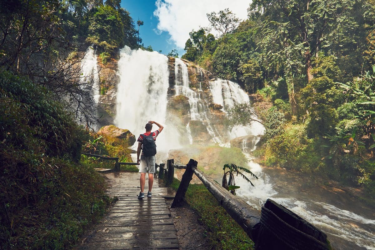 Traveller exploring Wachirathan Waterfall in a rainforest of Chiang Mai