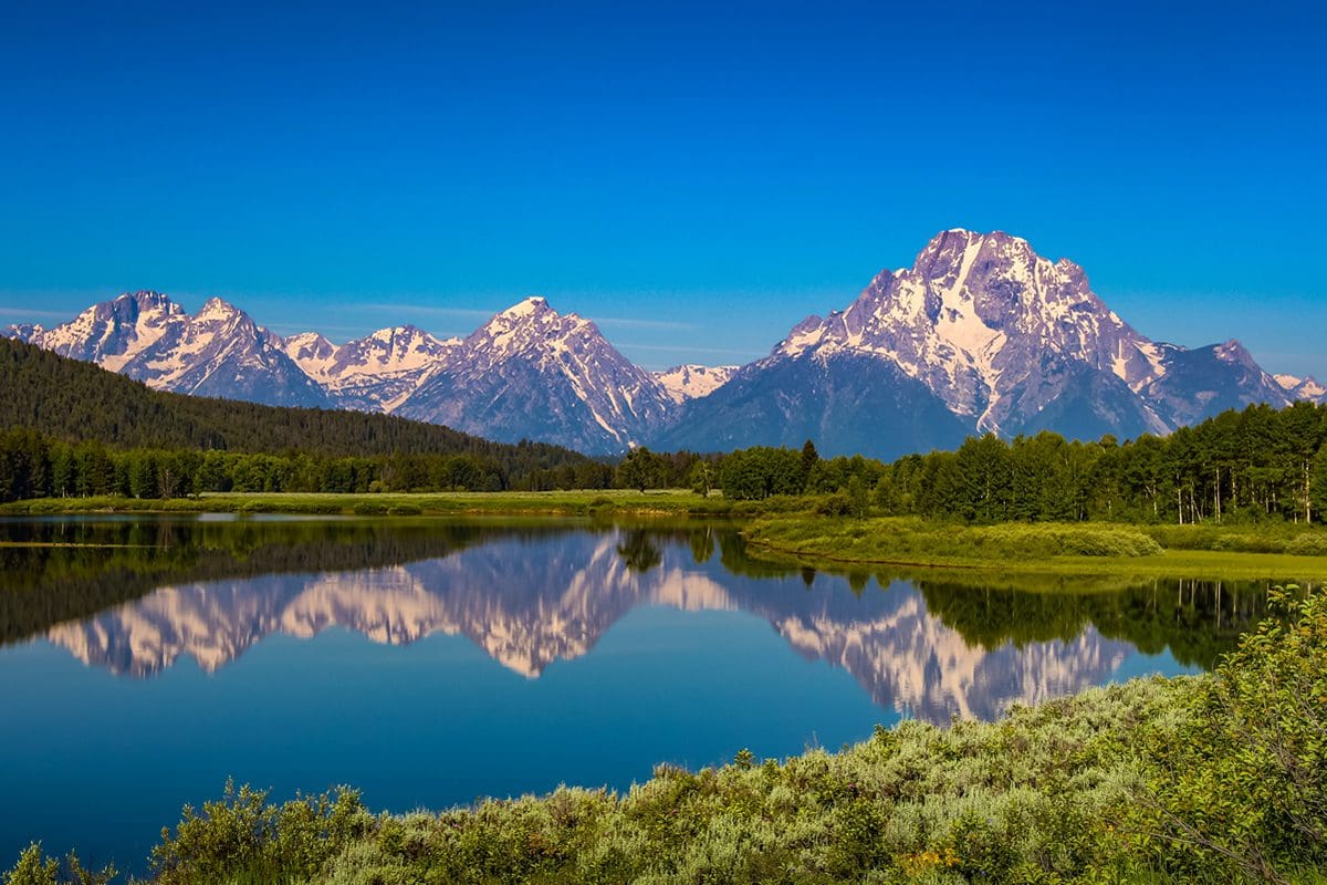 Water reflecting snow-capped mountains in Yellowstone