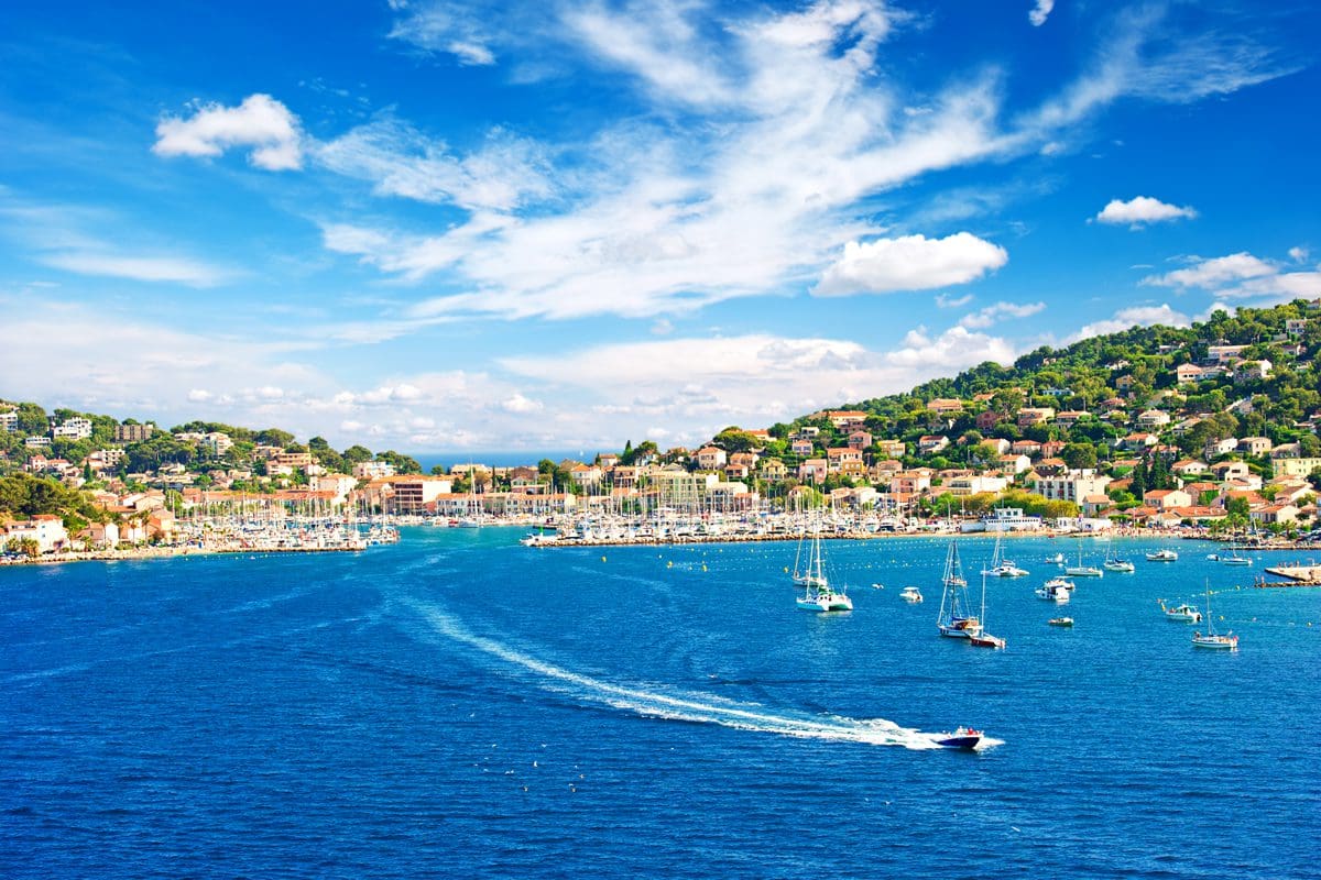 Boats dotted along the coastline of the French Riviera