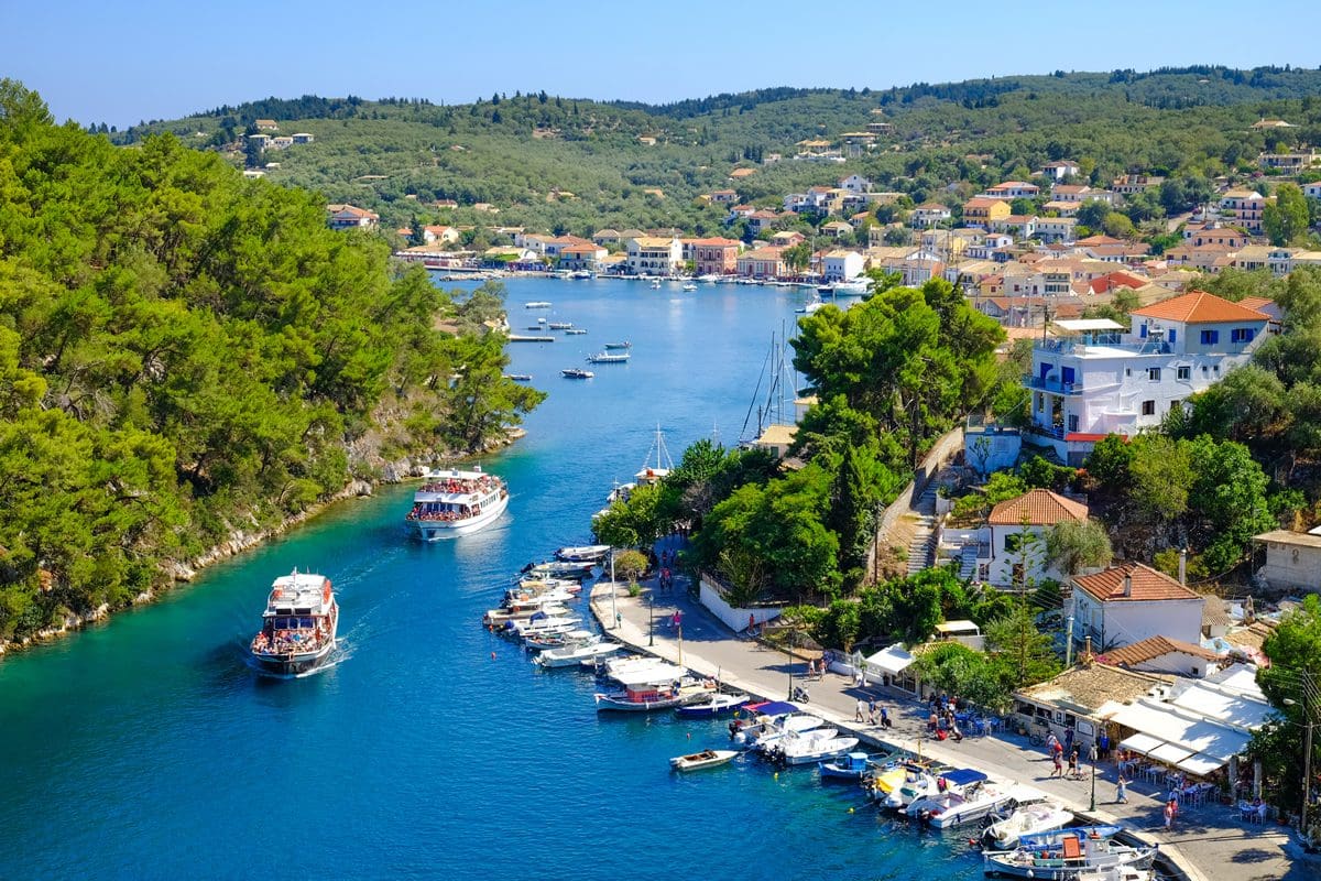 Tourist boats entering a canal in Paxos