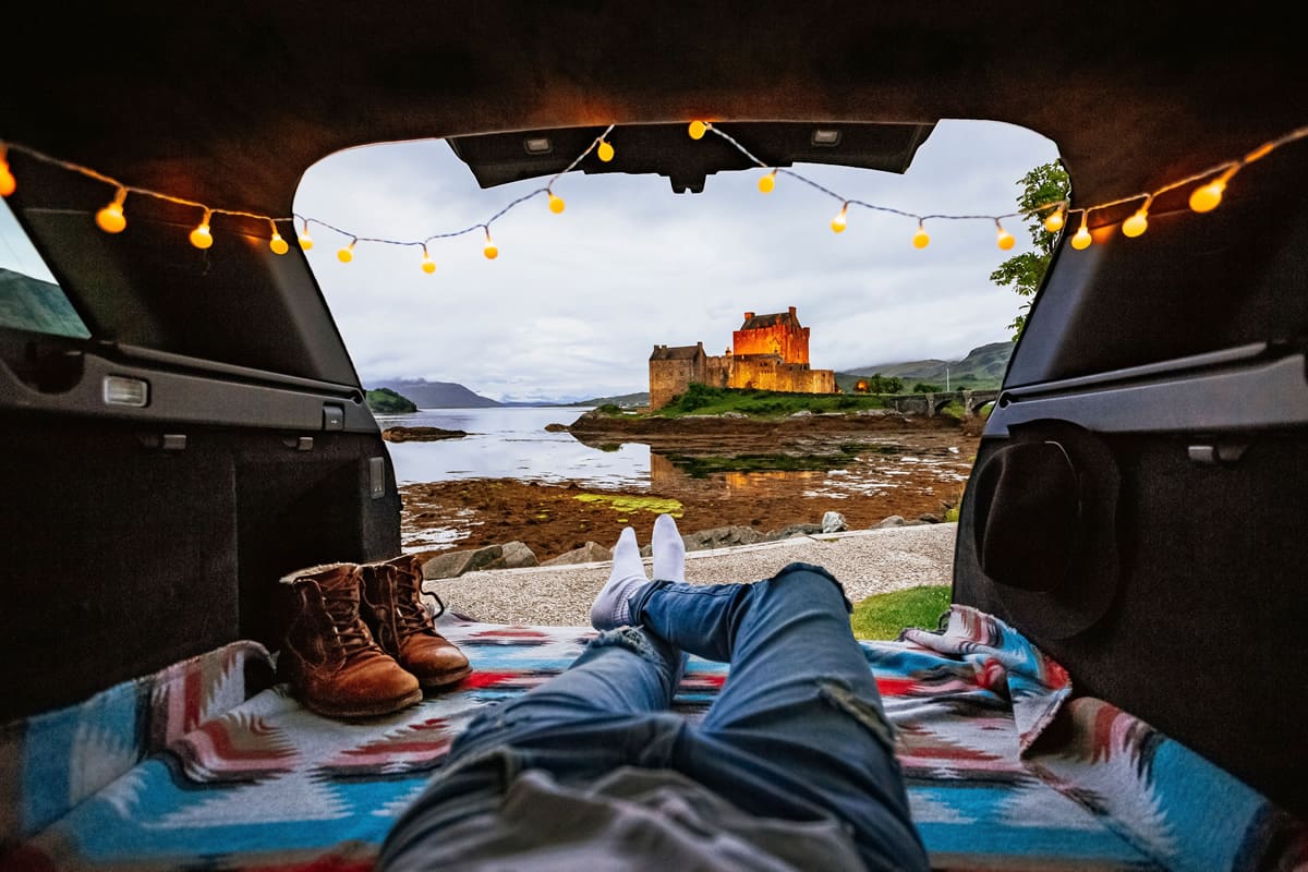 Admiring Eilean Donan Castle's views from a camper van in Scotland - Visit Britain/James Relf Dyer