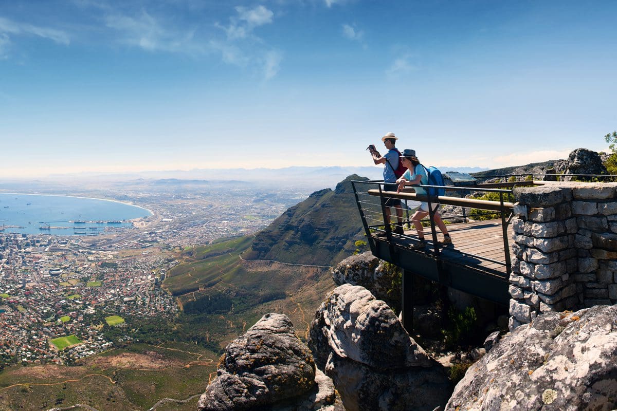 Couple enjoying the view of Cape Town from Table Mountain - South African Tourism