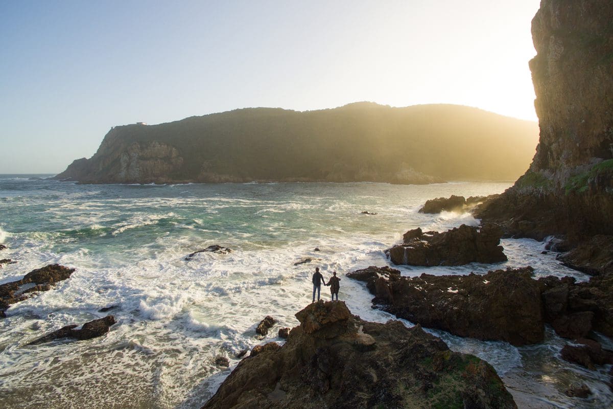 Couple watching the waves at Coney Glen in Knysna - South African Tourism