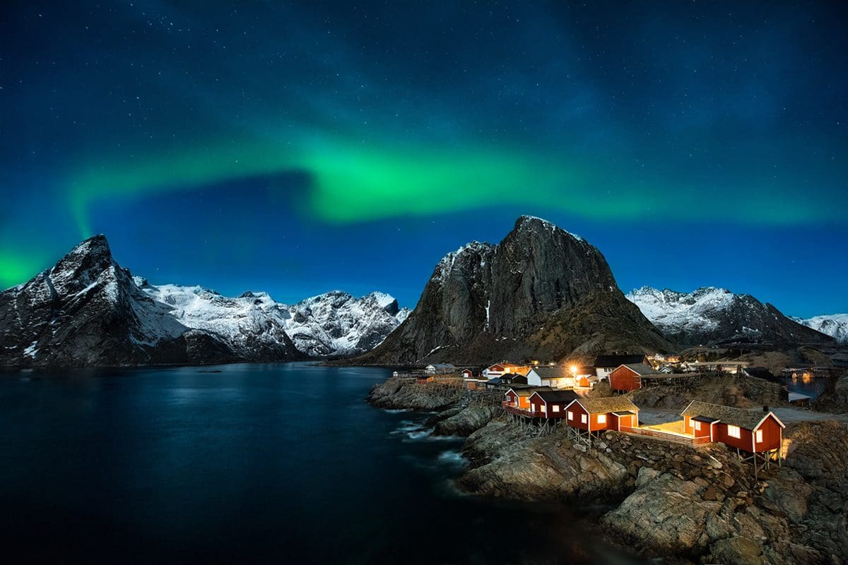 Winter dawn with the aurora borealis over Reine Lofoten in Northern Norway