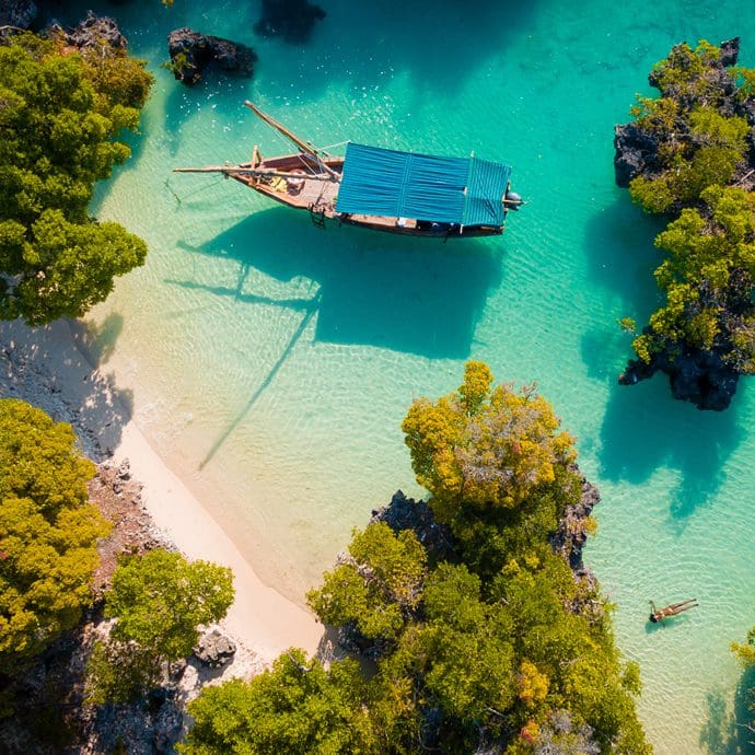 Aerial view of a boat by the beach on Pamunda Island, Zanzibar