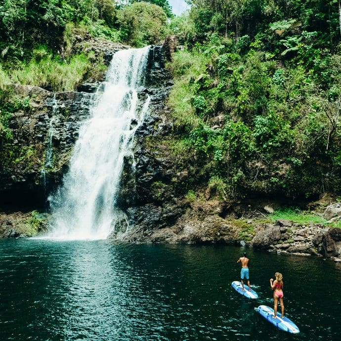 Couple paddleboarding at Kulaniapia Falls on the island of Hawaii - Hawaii Tourism Authority