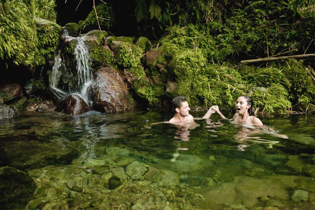 Couple enjoying a waterfall pool - St Kitts Tourism