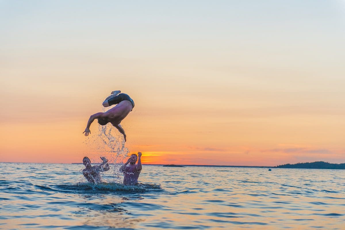 Playing in the water of Pointe Taillon National Park - Quebec Tourism/Steve Deschenes