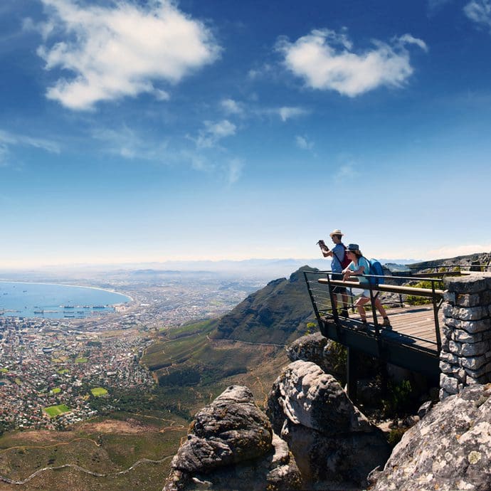 Couple enjoying the view of Cape Town from Table Mountain - South African Tourism