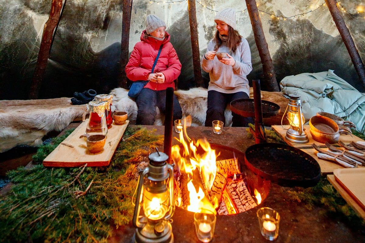 Mother and daughter relaxing in a Finnish hut