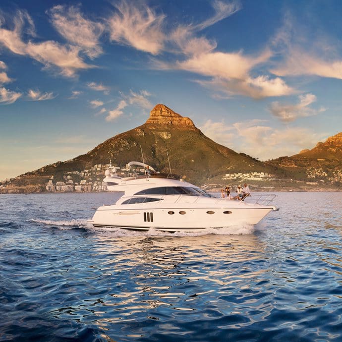 Yacht in Camps Bay under Twelve Apostles - South Africa Tourism