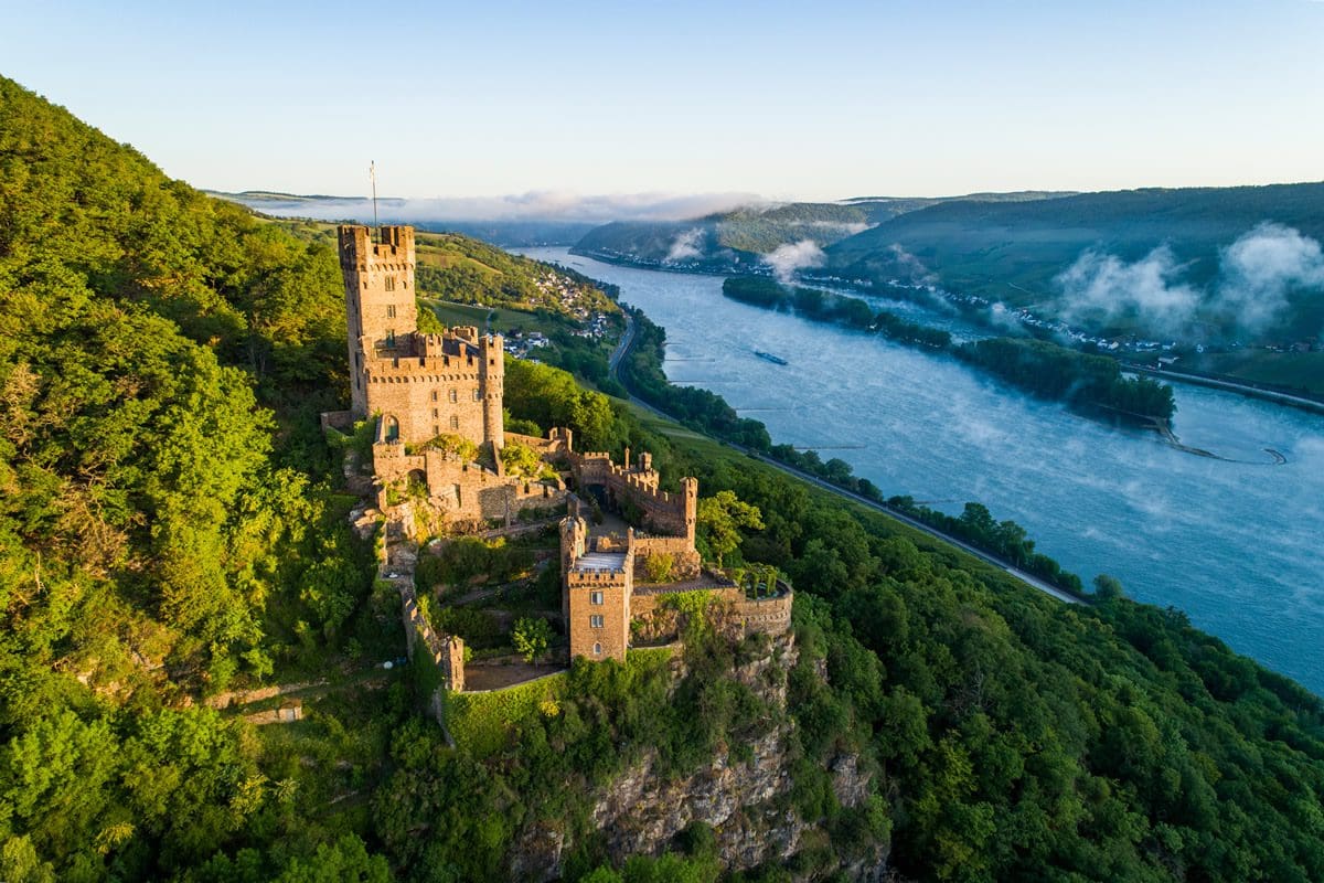 Aerial view of Sooneck Castle surrounded by the Bingen Forest with a view of the Rhine - Rheintouristik Tal der Loreley/Mahlow Media