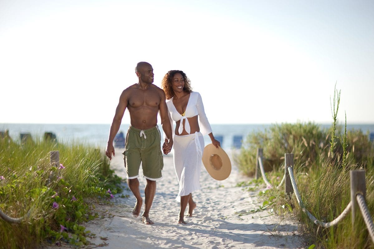 Couple walking from the beach - Lee County Visitor Convention Bureau/Jason Lindsey