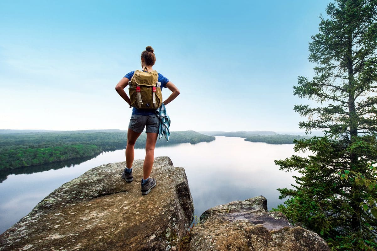 Lady hiking Grand Marais Honeymoon Bluff - Explore Minnesota/Roy Son