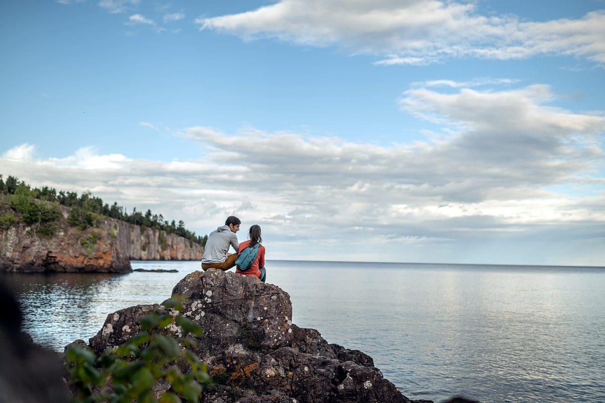 Couple relaxing at Silver Bay, Tettegouche State Park - Explore Minnesota/Ryan Taylor