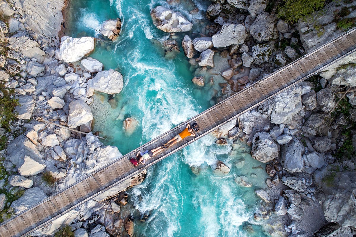 Hikers on a bridge over the Soca River - Slovenia Tourism/Jost Gantar