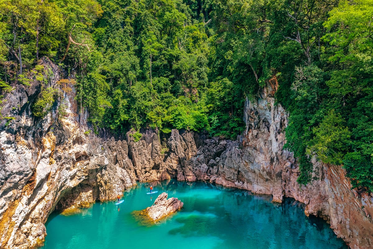 Stand-up paddleboarding at Ratchaprapha Dam, Khao Sok National Park - Tourism Authority of Thailand