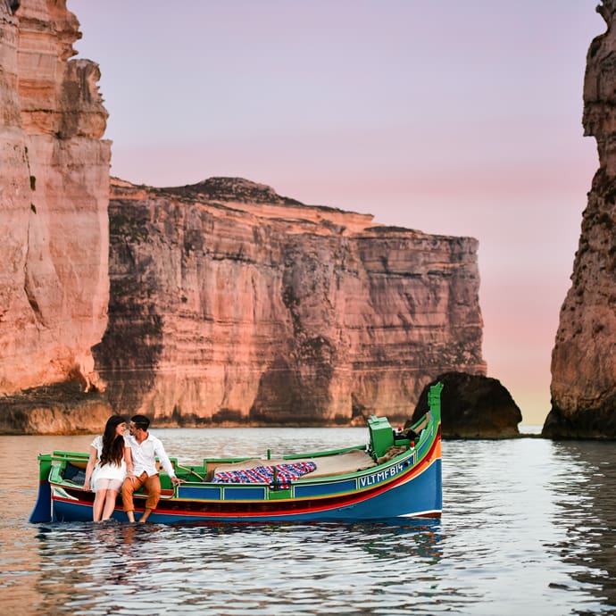 Couple on a boat in Dwejra Bay, San Lawrenz, Gozo – Visit Malta