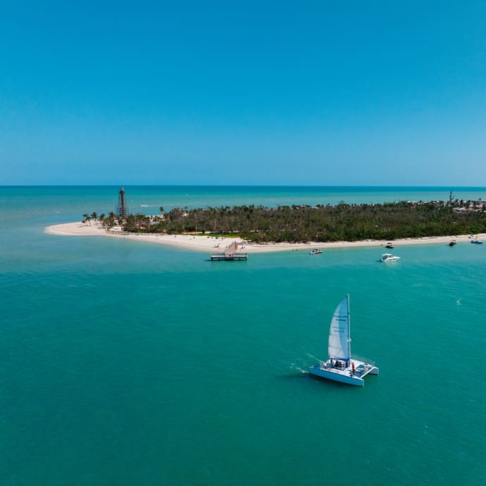 Sailing by Sanibel Island Lighthouse - Lee County Visitor Convention Bureau/The Beaches of Fort Myers & Sanibel