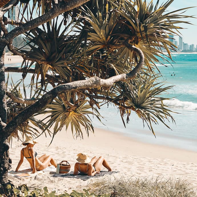 Enjoying the sun on the beach at Burleigh Heads on Queensland’s Gold Coast – Tourism Australia