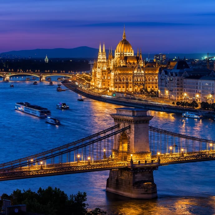 Illuminated Chain Bridge and Hungarian Parliament building on the Danube River in Budapest
